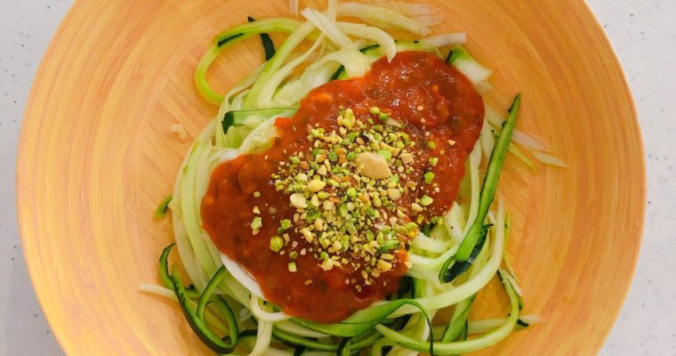 Guilt-Free Zoodles Pasta with Marinara Sauce topped with Vegan Uncheesy Parmesan